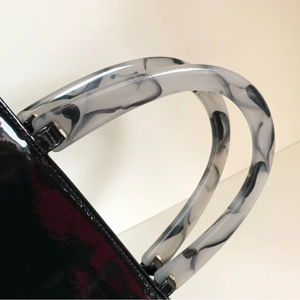 Hold NWOT Neiman Marcus black patent marble handle modern bag